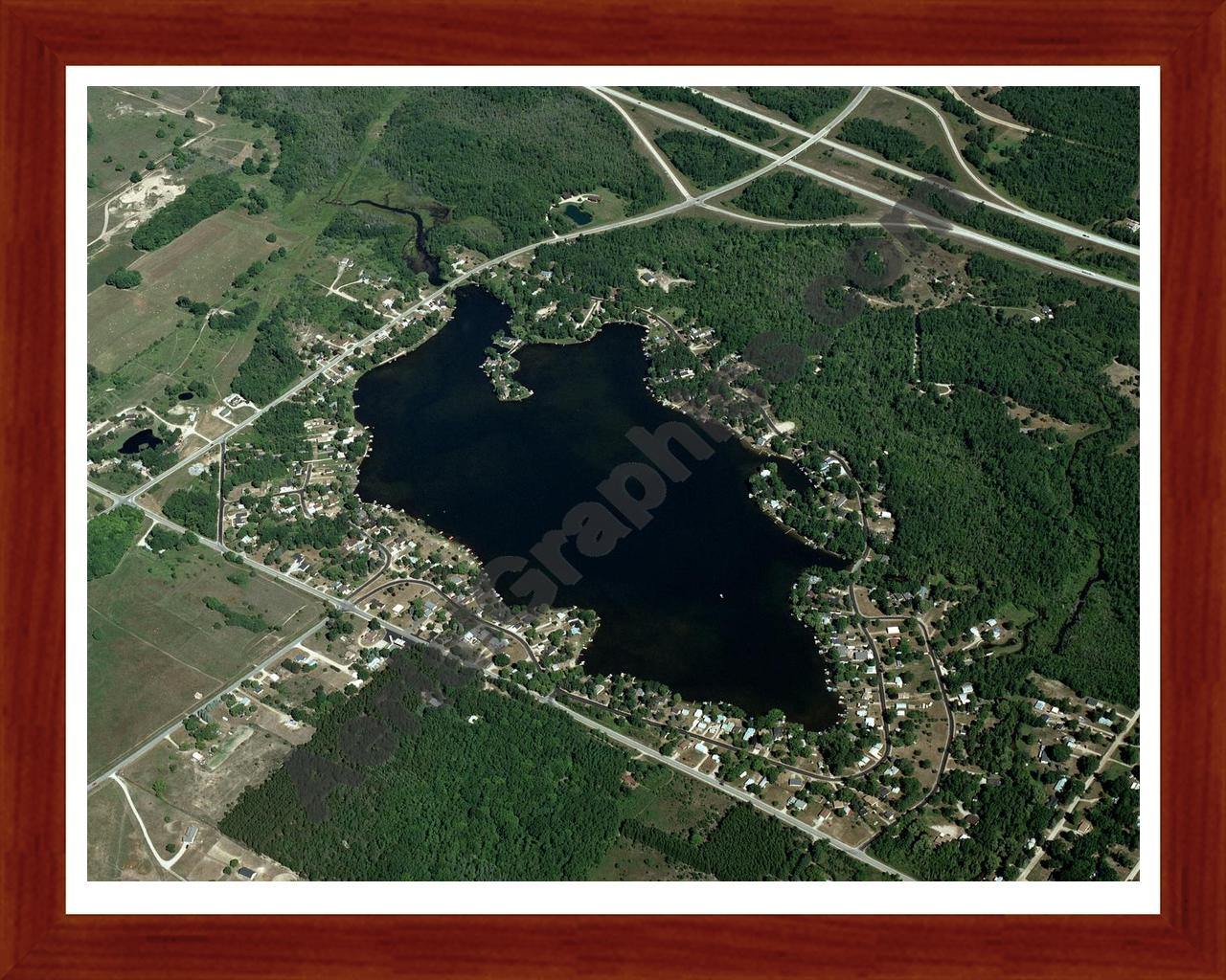 Aerial image of [3247] Lake Thirteen in Clare, MI with Cherry Wood frame