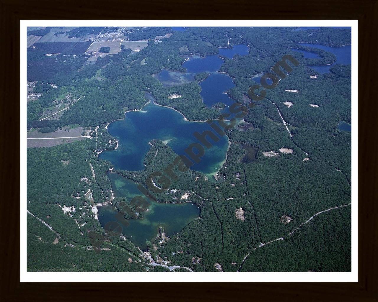 Aerial image of [3920] Arbutus Lake in Grand Traverse, MI with Black Wood frame