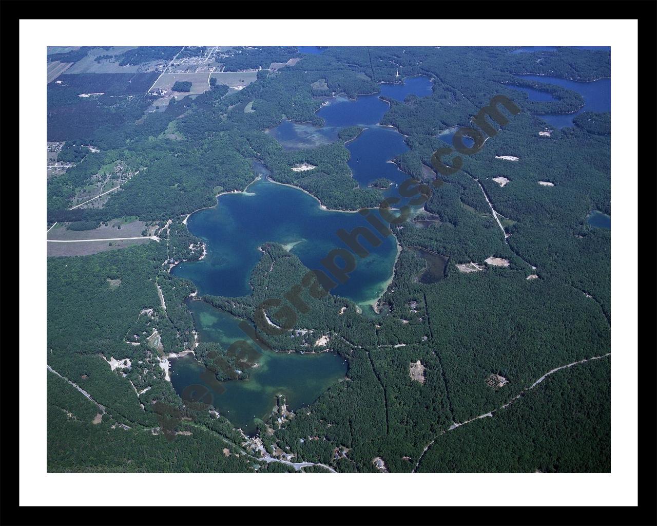 Aerial image of [3920] Arbutus Lake in Grand Traverse, MI with Black Metal frame