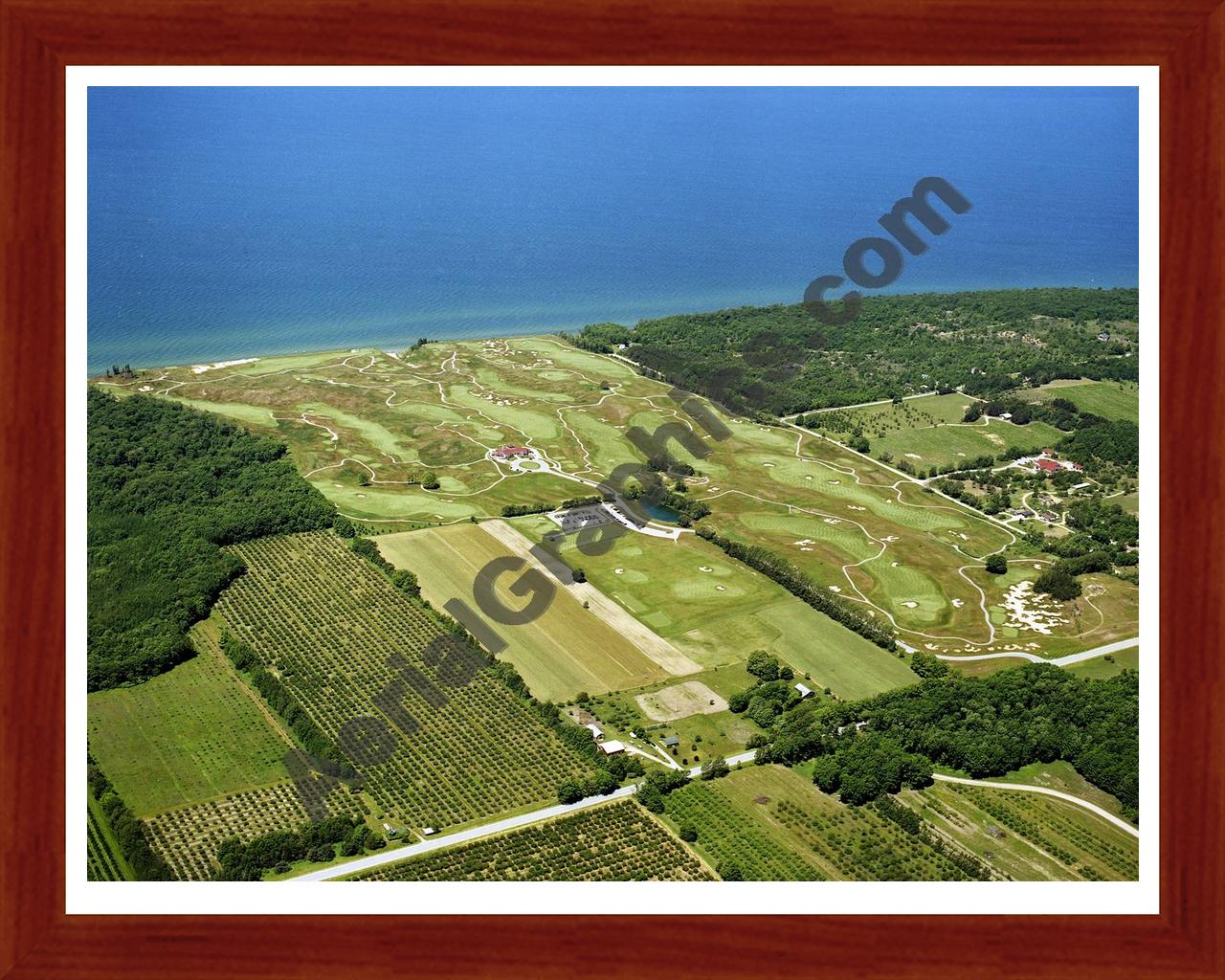 Aerial image of [4248] Arcadia Bluffs Golf Club looking West with Cherry Wood frame