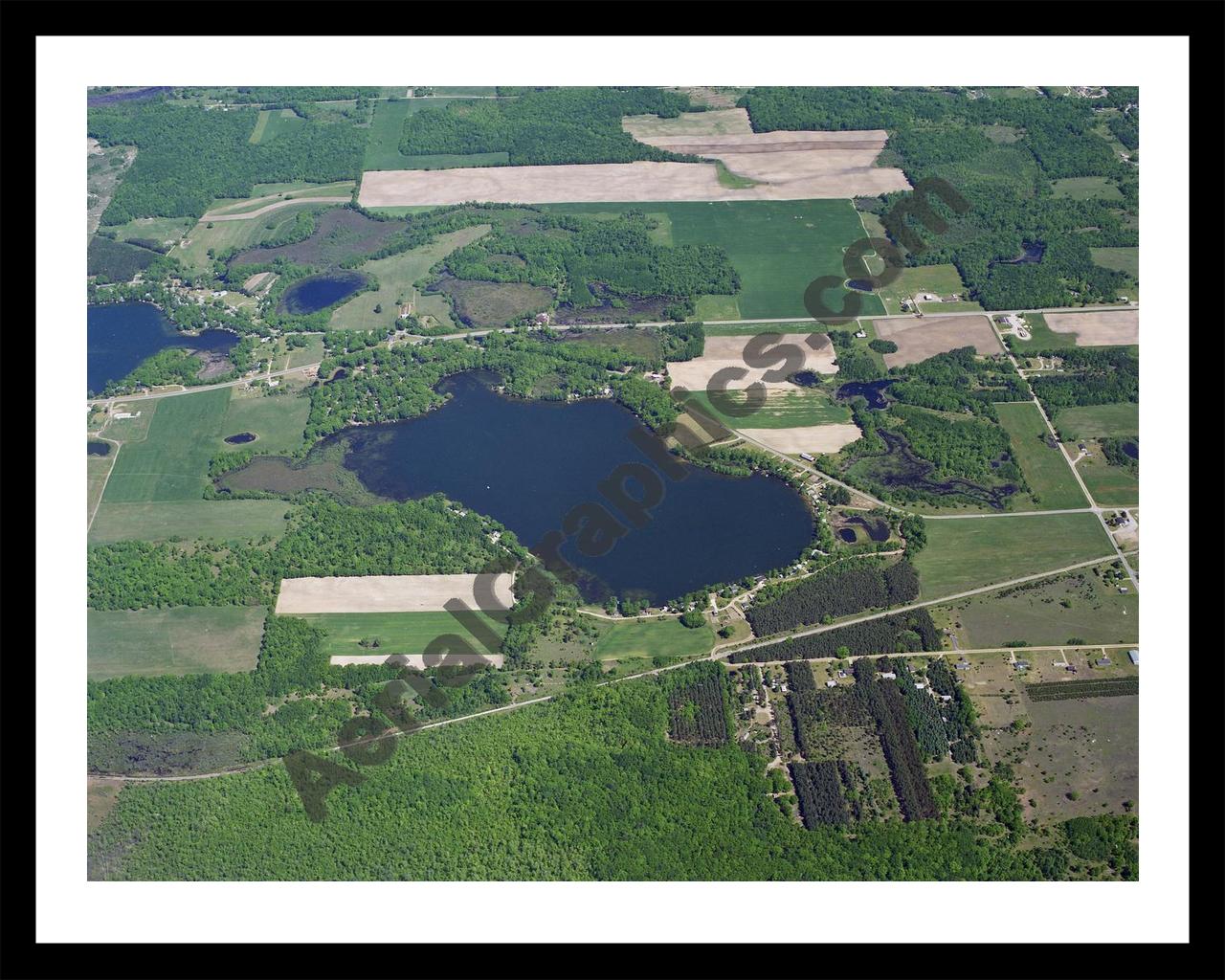 Aerial image of [42] Bass Lake (Richland Twp) in Montcalm, MI with Black Metal frame