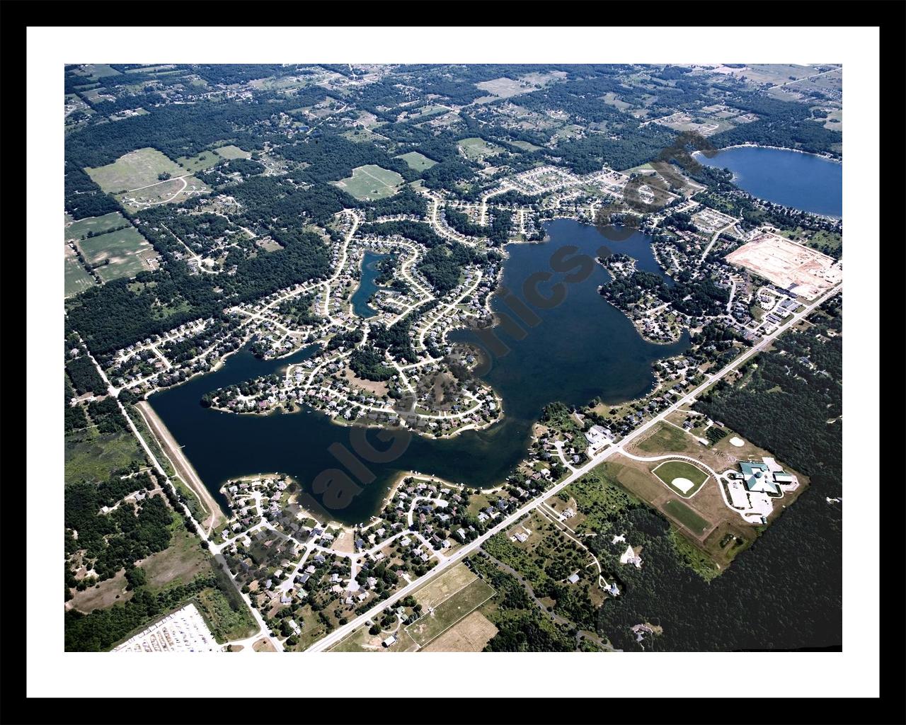 Aerial image of [4998] Lake Bella Vista in Kent, MI with Black Metal frame