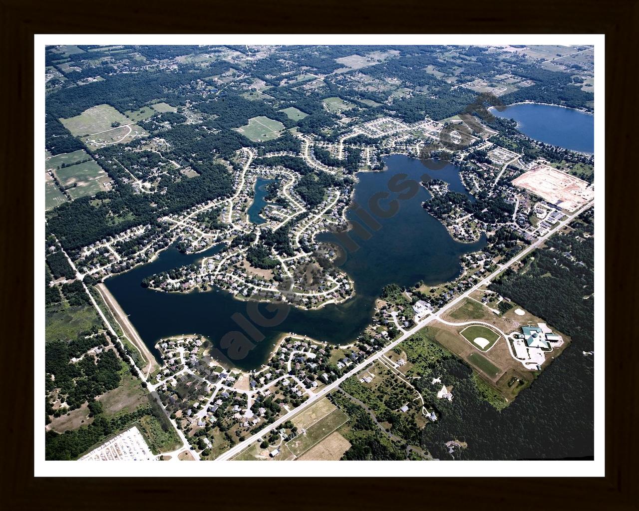 Aerial image of [4998] Lake Bella Vista in Kent, MI with Black Wood frame