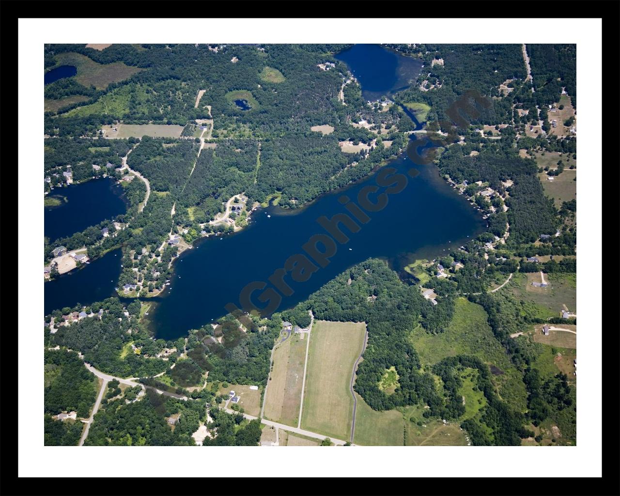 Aerial image of [5014] Woodbeck Lake in Kent, MI with Black Metal frame