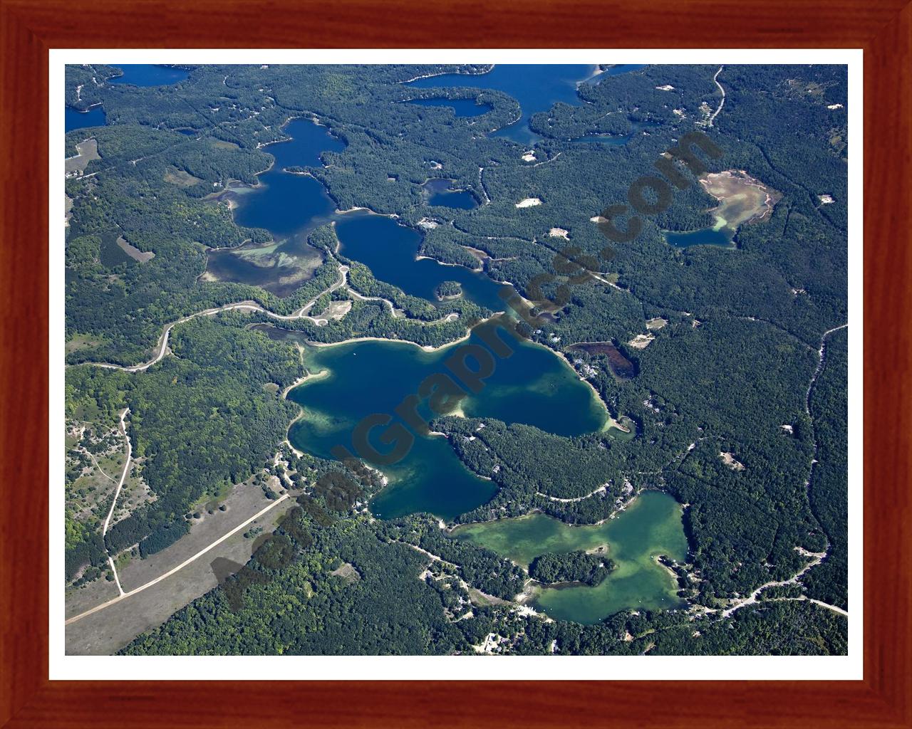 Aerial image of [5604] Arbutus Lake in Grand Traverse, MI with Cherry Wood frame