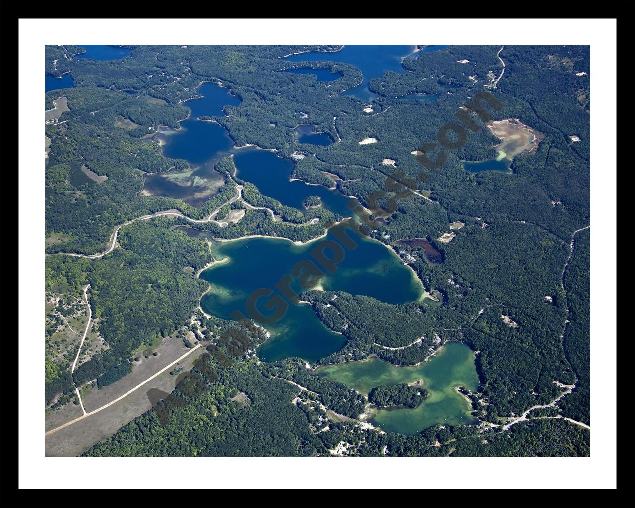 Aerial image of [5604] Arbutus Lake in Grand Traverse, MI with Black Metal frame