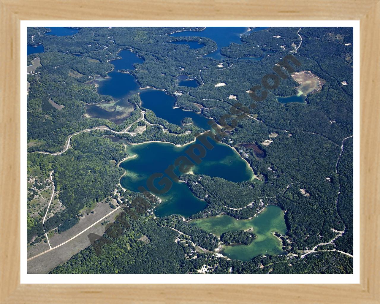 Aerial image of [5604] Arbutus Lake in Grand Traverse, MI with Natural Wood frame