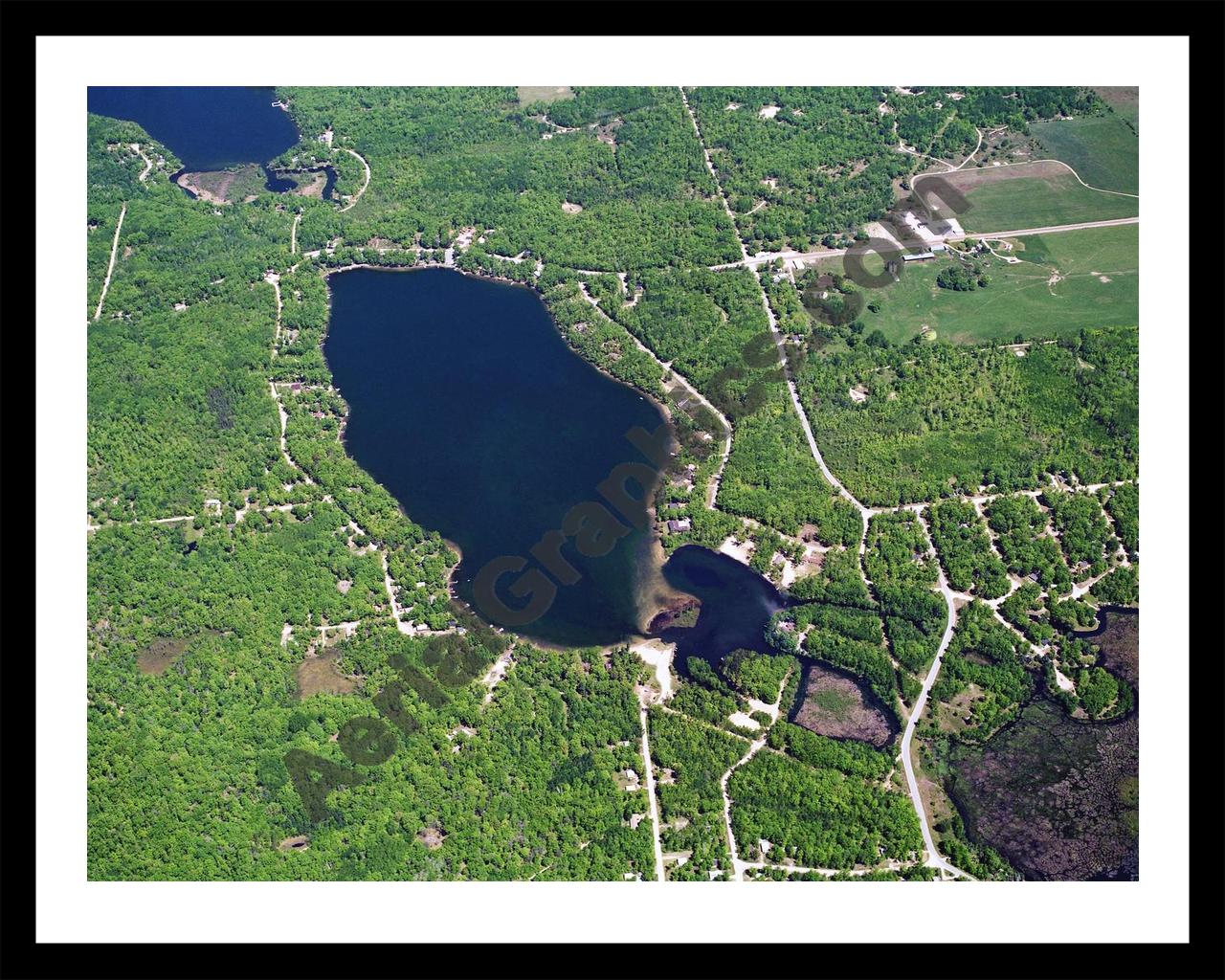 Aerial image of [5872] Arnold Lake in Clare, MI with Black Metal frame