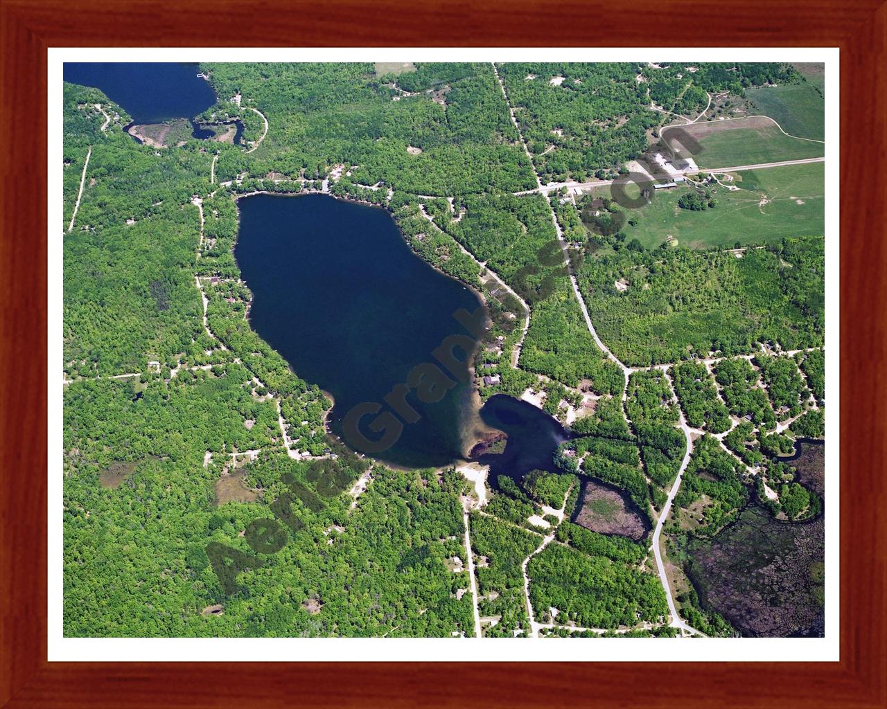 Aerial image of [5872] Arnold Lake in Clare, MI with Cherry Wood frame